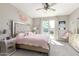 Bright bedroom with a large window, ceiling fan, and a king-sized bed with stylish decor at 20729 E Canary Way, Queen Creek, AZ 85142