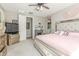 Comfortable bedroom featuring a fireplace, TV, ceiling fan, and a king-sized bed with decorative pillows at 20729 E Canary Way, Queen Creek, AZ 85142