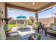Charming covered patio with comfortable seating, perfect for relaxing and enjoying the outdoor space at 20729 E Canary Way, Queen Creek, AZ 85142