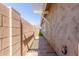 Narrow side yard features pavers, a light-colored wall, and a thin strip of artificial grass at 20729 E Canary Way, Queen Creek, AZ 85142