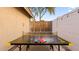 Backyard area with ping pong table, string lights and privacy wall at 21630 N 30Th Ln, Phoenix, AZ 85027