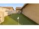 Backyard putting green with Arizona themed cornhole boards for outdoor fun and games at 21630 N 30Th Ln, Phoenix, AZ 85027