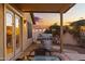 Covered backyard patio with a stainless steel grill, dining area, and access to the indoors through elegant French doors at 21630 N 30Th Ln, Phoenix, AZ 85027