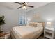 Comfortable bedroom features a ceiling fan, plantation shutters and cool colors at 21630 N 30Th Ln, Phoenix, AZ 85027