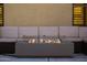 Close-up of a modern fire pit surrounded by comfortable outdoor seating, ideal for relaxing evenings in the backyard at 21630 N 30Th Ln, Phoenix, AZ 85027