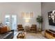 Living room featuring bright, natural light from the French doors, stylish decor, and comfortable seating at 21630 N 30Th Ln, Phoenix, AZ 85027