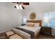Bright main bedroom with a ceiling fan, shuttered windows, and stylish furniture at 21630 N 30Th Ln, Phoenix, AZ 85027