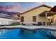 Inviting backyard with a shimmering pool, comfortable seating, and a putting green for leisure and entertainment at 21630 N 30Th Ln, Phoenix, AZ 85027