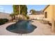 Spacious backyard with a stunning pool, lush landscaping, cozy seating area, and a modern fire pit for outdoor enjoyment at 21630 N 30Th Ln, Phoenix, AZ 85027