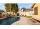Relaxing backyard oasis with a sparkling pool, rock waterfall feature, and comfortable lounge area at 21630 N 30Th Ln, Phoenix, AZ 85027