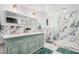 Bright bathroom with marble walls, a double sink vanity, a walk-in shower with a glass door and gold accents at 2324 N 40Th St, Phoenix, AZ 85008