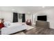 Bright bedroom with white bedding, dark curtains, a large window, and a wood-look floor at 2324 N 40Th St, Phoenix, AZ 85008
