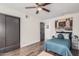 Bedroom featuring a ceiling fan, sliding closet door, and bed with blue quilted bedspread at 2324 N 40Th St, Phoenix, AZ 85008
