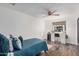 Bedroom with a ceiling fan, vanity and light up mirror with a blue quilted bedspread at 2324 N 40Th St, Phoenix, AZ 85008