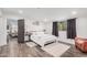 Bright and airy bedroom with a soft rug, comfortable chair, hardwood floors, and neutral tones at 2324 N 40Th St, Phoenix, AZ 85008