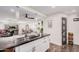 Open concept kitchen with island sink, white cabinetry, dark countertops and hardwood flooring at 2324 N 40Th St, Phoenix, AZ 85008