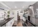 Modern kitchen with island sink, white cabinetry, dark countertops and hardwood flooring at 2324 N 40Th St, Phoenix, AZ 85008