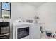 Laundry room featuring a washer and dryer, as well as a water dispenser and shelving at 2324 N 40Th St, Phoenix, AZ 85008