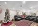 Spacious living room with a large leather sectional sofa, a rug, and a Christmas tree at 2324 N 40Th St, Phoenix, AZ 85008