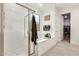 This bathroom features a bathtub, walk-in shower and a doorway to the closet at 24441 N 142Nd Dr, Surprise, AZ 85387