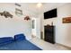 Bedroom featuring blue comforter, carpeted floors, wall-mounted TV, and themed wall decor at 24441 N 142Nd Dr, Surprise, AZ 85387