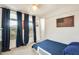 Bright bedroom with large windows, neutral carpet, and blue drapes and bedspread at 24441 N 142Nd Dr, Surprise, AZ 85387