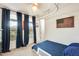 Bedroom featuring window with blue curtains, bed and hanging American flag at 24441 N 142Nd Dr, Surprise, AZ 85387