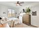 Bedroom with a ceiling fan, decor, and a large window with blinds at 24441 N 142Nd Dr, Surprise, AZ 85387