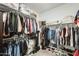 Walk-in closet equipped with shelves, racks, and an area for shoe storage at 24441 N 142Nd Dr, Surprise, AZ 85387