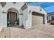 Welcoming entrance with brick pathway leading to the door and two car garage at 24441 N 142Nd Dr, Surprise, AZ 85387