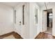 Bright entryway with wood flooring and a white front door with sidelight window at 24441 N 142Nd Dr, Surprise, AZ 85387