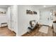 Entryway featuring wood-look floors, a bench with pillows, and decorative wall art at 24441 N 142Nd Dr, Surprise, AZ 85387