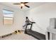 Exercise room with a ceiling fan, window and a treadmill at 24441 N 142Nd Dr, Surprise, AZ 85387