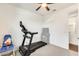Exercise room with a ceiling fan, window and a treadmill at 24441 N 142Nd Dr, Surprise, AZ 85387