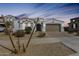 Charming single-story home featuring a neutral color palette, well-kept landscape, and a two-car garage at 24441 N 142Nd Dr, Surprise, AZ 85387