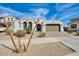 Charming single-story home featuring a neutral color palette, well-kept landscape, and a two-car garage at 24441 N 142Nd Dr, Surprise, AZ 85387