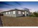 Exterior view of the home, highlighting the yard and gated area at 24441 N 142Nd Dr, Surprise, AZ 85387