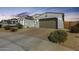 Charming home exterior with desert landscaping and a spacious driveway at 24441 N 142Nd Dr, Surprise, AZ 85387