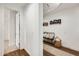 Hallway with dark wood-look flooring and an area with a bench and decor at 24441 N 142Nd Dr, Surprise, AZ 85387
