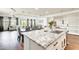 Spacious kitchen with open concept view towards the Gathering room with a large kitchen island and stainless appliances at 24441 N 142Nd Dr, Surprise, AZ 85387