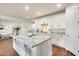 Kitchen featuring a white island with granite countertop, stainless appliances and sliding door access to adjacent room at 24441 N 142Nd Dr, Surprise, AZ 85387