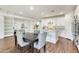 Well-lit kitchen featuring a large island with granite countertops and a nearby table with upholstered chairs at 24441 N 142Nd Dr, Surprise, AZ 85387