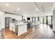 Bright, open-concept kitchen with stainless appliances, white cabinetry and granite countertops overlooks the living area at 24441 N 142Nd Dr, Surprise, AZ 85387
