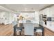 Bright kitchen with granite countertops, white cabinets and a table with upholstered chairs at 24441 N 142Nd Dr, Surprise, AZ 85387