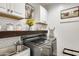 Functional laundry room with stainless steel washer/dryer, custom cabinets, and farmhouse decorations at 24441 N 142Nd Dr, Surprise, AZ 85387