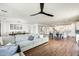Open-concept living area featuring a sectional sofa, dining set, and a modern kitchen with white cabinetry and island at 24441 N 142Nd Dr, Surprise, AZ 85387