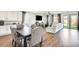 Open concept living room featuring a dining area, kitchen, and large sectional sofa with a flat-screen TV at 24441 N 142Nd Dr, Surprise, AZ 85387