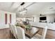 Open concept living space showcasing dining area, kitchen with white cabinetry and a comfortable living room at 24441 N 142Nd Dr, Surprise, AZ 85387