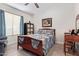 Bedroom with light and dark wood furniture, large window and fan at 24617 N 49Th Ave, Glendale, AZ 85310