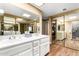 Bright bathroom with a double sink vanity and mirrored closet doors at 25261 S Berry Brook Dr, Sun Lakes, AZ 85248